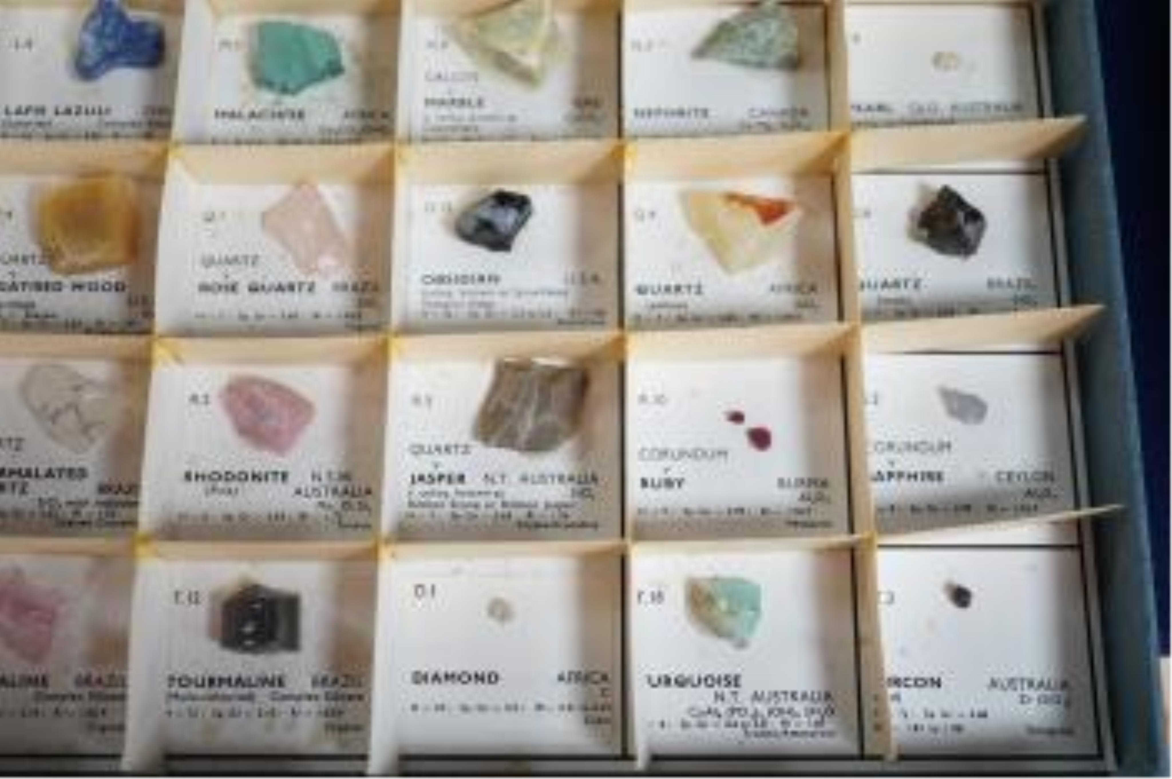 Three boxes containing unmounted cut gemstones including topaz, citrine, peridot, zircon, moonstone, etc. Fair condition.
